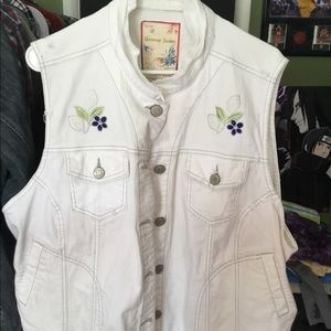 White vest with blue flower patches.